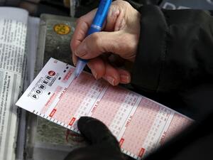 A woman fills out a ticket for the Powerball lottery draw at Times Square in the Manhattan. (AFP/ File)