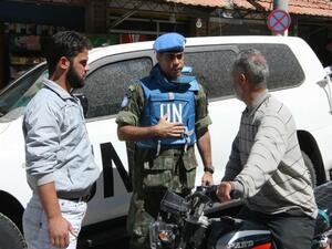 A UN official speaks with locals in the town of Madaya, in Syria, on May 6 2012. (AFP/Louai Beshara)