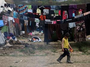 A migrant boy walks at the makeshift camp at the Greek-Macedonian border, near the Greek village of Idomeni on March 30, 2016, where thousands of refugees and migrants are stranded by the Balkan border blockade. (AFP/Sakis Mitrolidis)