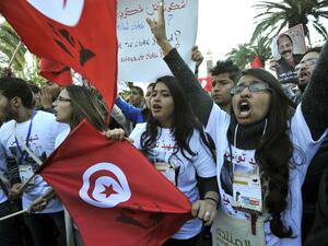 Tunisian women shout slogans during a demostration in the center of Tunis after the opening of the World Social Forum (WSF) on March 26, 2013. More than two years after the Jasmine revolution, tens of thousands of people are expected for the WSF, dubbed the forum of "dignity", a watchword of the Tunisian uprising that inspired revolts across the Arab world. (AFP PHOTO/FETHI BELAID)