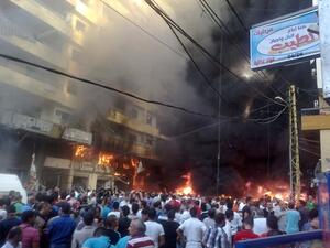 Lebanese people gather at the site of a car bomb between the Bir el-Abed and Roueiss neighbourhoods, in the southern suburb of Beirut on August 15, 2013. A powerful car bomb killed at least three people and wounded several others in a Beirut stronghold of Lebanon's Shiite movement Hezbollah, national news agency NNA reported. (AFP)