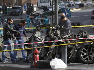 Lebanese police forensic experts inspect the wreckage of a car at the site of a powerful car bomb explosion on December 28, 2013 that rocked central Beirut the previous day. [AFP]