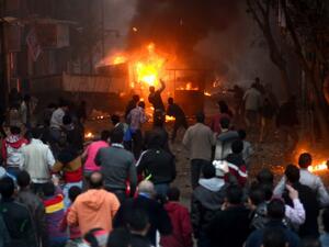 Supporters of the Muslim Brotherhood clash with civilians and Egyptian riot police in Alf Masskan district in the capital Cairo on January 17, 2014. [AFP]