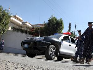 Guards on watch after an unknown assailant killed an Iranian diplomat in a drive-by shooting outside the ambassador's residence in the Yemeni capital. [AFP]