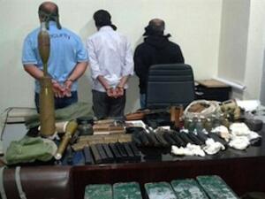In this picture released by the State Security on Friday, Sept. 20, 2013, blindfolded suspects stand near seized weapons and explosives. (The Daily Star/NNA, HO)