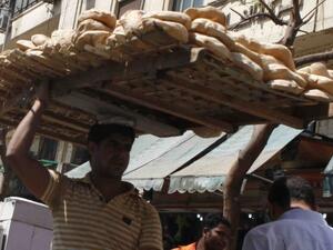 Street vendor distributing bread in Egypt