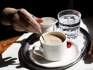 Woman presents a tray of beverages (Getty: image used for illustrative purposes)