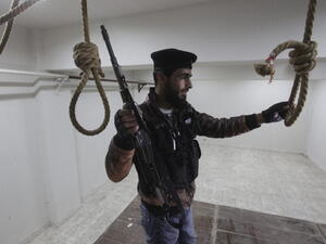 A Free Syrian Army soldier in a room where political prisoners were hanged by Al-Assad forces inside the central prison on April 23, 2013, in Darkoush, Syria. [Getty Images]