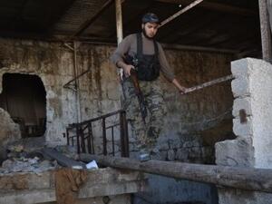 An opposition fighter walks along a log in the northern Syrian city of Aleppo on October 6, 2013. Syria's army took back control of a strategic town in the northern province of Aleppo on October 3, after a weeks-long battle for the city. (AFP) 
