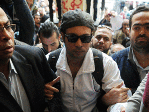 Mohamed Adel is seen with Ahmed Maher , founder and former leader of the "April 6" movement, when Maher turned himself in at Abddein court in Cairo, November 30, 2013.