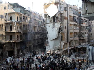 Syrians search for survivors amidst the rubble following an airstrike in the Shaar neighborhood of Aleppo on December 17, 2013. [AFP]