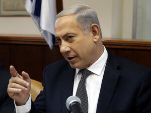 Israeli Prime Minister Benjamin Netanyahu gestures as he opens the weekly cabinet meeting at his Jerusalem office on December 22, 2013. [AFP]