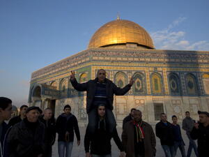 Recently released Palestinian prisoner Ahmad Khalaf  is carried by friends in front of the Dome of the Rock at the Al-Aqsa mosque compound in the Old City of Jerusalem on December 31, 2013. [Getty Images]