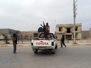 Armed men roam a street in the western, mainly Sunni Muslim city of Ramadi, the capital of the Anbar province, on January 4, 2014, as parts of Ramadi and the city of Fallujah. [Getty Images]
