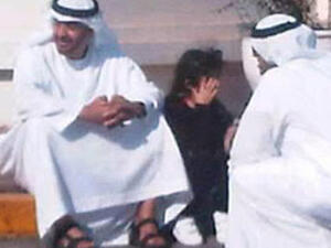 Abu Dhabi Crown Prince Sheikh Mohammed takes a break from his billions and waits with a schoolgirl.