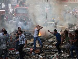 Lebanese civilians and emergency personnel gather at the site of a car bomb between the Bir el-Abed and Roueiss neighbourhoods, in the southern suburb of Beirut on August 15, 2013. (AFP)