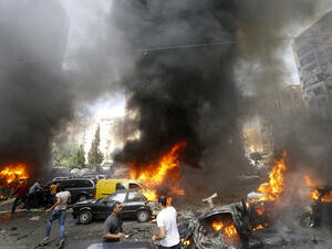 Civilians gather at the of an explosion in Beirut's southern suburb neighbourhood of Bir al-Abed on July 9, 2013. (Source: AFP/STR)