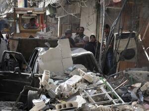 A mortar shell hit the Iraqi consulate in the Syrian capital Damascus Thursday, killing an Iraqi woman. The capital has been targeted by bombs and mortar shells in recent months. Here, Syrians inspect the sight of a car bomb attack in Damascus' Tadamun neighbourhood last week. (AFP)