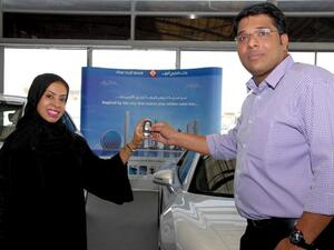 Huda Abdulla, Executive Vice President - Branch Distribution at First Gulf Bank presenting one of the half yearly draw winners with an Audi R8 Quattro