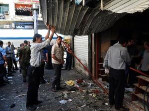 Syrians inspecting the damage in central Damascus following two explosions on Tuesday. AFP photo