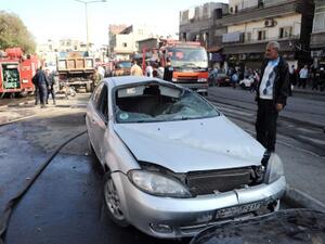 Fierce clashes raged across the suburbs of Damascus as a mortar shell hit the capital's ancient citadel. In this picture, released by SANA,  a man inspects a damaged car close to a textile plant which was hit by a mortar shell in an attack on the al-Dweila neighbourhood of southeast Damascus on November 3, 2013.(AFP/SANA)