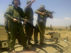 David Storobin poses with machine gun in hand