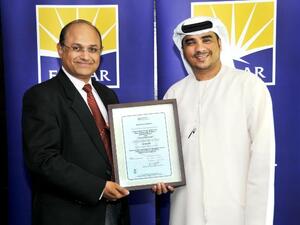 Ahmad Al Falasi, Executive Director and Jeevan J D’Mello, Senior Director of Emaar Community Management receiving the certification from Lloyds Register Quality Assurance