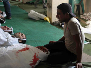An Egyptian youth mourns over bodies laid out in Tawhid Mosque, close to Ramses Square, in Cairo (AFP/KHALED KAMEL)