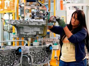 A General Motors employee works on the assembly line at Toledo Transmission Plant