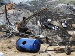 A Palestinian man inspects damage at a training site for the Al-Quds Brigades, the military wing of Islamic Jihad after on January 14, 2014 after it was hit by an Israeli air strike in Khan Younis in the southern Gaza Strip.