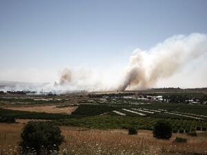 Smoke billows during clashes between Syrian rebels and forces loyal to the regime near the Quneitra crossing in the Golan Heights on Thursday. AFP Photo