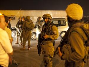 Israeli soldiers prevent Palestinians from leaving the southern West bank city of Hebron on September 22, 2013 after an Israeli soldier died after being shot by a suspected Palestinian gunman. (AFP)
