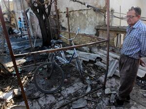 An Iraqi man inspects the site of a car bomb explosion in the Taubchi neighbourhood of the capital Baghdad on January 19, 2014, a day after the attack. (AFP)