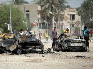 Iraqis inspect the scene of a car bomb attack near the office of Al-Ahad television channel, which is affiliated with a Shiite militant group, in Baghdad's eastern neighbourhood of Baladiyat on August 15, 2013. (AFP)