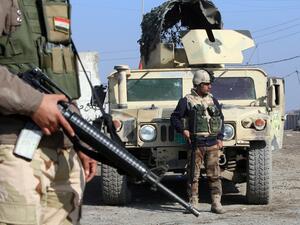 Iraqi soldiers monitor a checkpoint east of Baghdad on January 6, 2014. On Thursday, 13 Iraqi army recruits were killed by a suicide bomber in the capital city. (AFP)