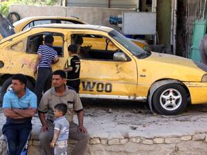 Iraqis look on at the site of a car bomb attack the evening, before in the Zafaraniyah area south of Baghdad, on October 8, 2013. A wave of car and roadside bombs hit Iraq on Sunday morning, killing at least 8 people. (AFP)
