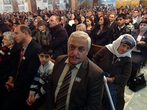 Iraqi Christians take part in Christmas celebrations during mass at the Chaldean Sacred Heart Cathedral in the northern city of Kirkuk, 240 kms (150 miles) from Baghdad on December 24, 2013. (AFP)