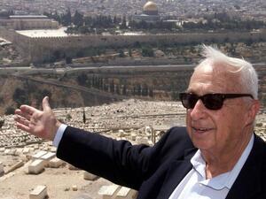 Opposition leader Ariel Sharon of the right-wing Likud gestures towards Jerusalem's Old City 24 July 2000 on the Mount of Olives during a rally to protest any land concessions in Jerusalem to the Palestinians. (AFP/File)