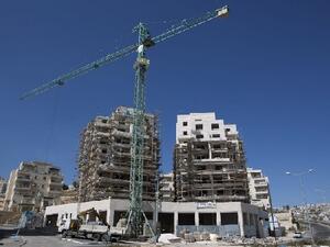 Labourers work on the construction of home in the Israeli settlement of Har Homa in Israeli annexed Arab East Jerusalem (file AFP)
