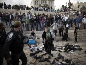 A Palestinian woman yells at Israeli security forces during a demonstration in front of Jerusalem's old city's Damascus gate on Tuesday. Israeli forces on Wednesday stormed the Al Aqsa mosque compound, the third holiest site in Islam. (AFP)
