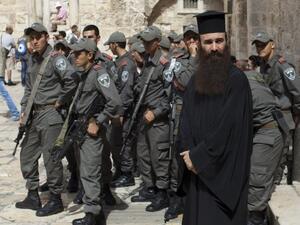Israeli border police gather in the area of the Church of the Holy Sepulchre in Jerusalem's Old City on October 6, 2013, as Palestinian Christians rally during a demonstration against acts of vandalism on Christian sites in Jerusalem. (AFP)