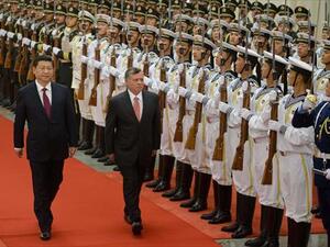 Jordan's King Abdullah II (C) and China's President Xi Jinping (L) review an honour guard during a welcoming ceremony at the Great Hall of the People in Beijing on Wednesday. (AFP)
