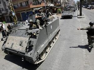Lebanese army soldiers patrol Syria street in Tripoli earlier this month. They have warned Syria with "security measures" if any more rockets land in the country. AFP photo