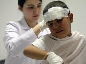 A nurse attends to a wounded boy in the eastern Lebanese city of Baalbek, near the Syrian border. Later reports suggested the boys injuries may have been caused by a Syrian airstrike by the Lebanese border (AFP/STR)