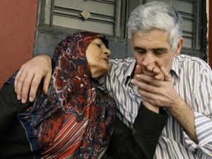 Abbas Hammoud, one of the nine Lebanese pilgrims held hostage in Syria for 17 months, is welcomed by his mother Mayla Aldurr upon his arrival at his home in the coastal city of Tyre in south Lebanon on October 20, 2013. On Wednesday, an activist announced that the Syrian authorities had released 14 women detained in the country as part of a hostage exchange deal. (AFP)