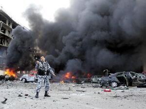 A picture taken on February 14, 2005 shows a Lebanese police officer gesturing on the site of an explosion which killed former Lebanese premier Rafiq Hariri and 21 others in Beirut. The Beirut government is in paralysis, business deals are on hold and tongues abuzz with rumours as Lebanon anxiously awaits indictments by a UN tribunal probing Hariri&#039;s murder.