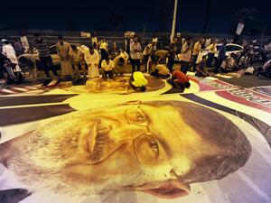Members of the Muslim Brotherhood pray on posters of ousted Egyptian president Mohamed Mursi (AFP/FAYEZ NURELDINE)