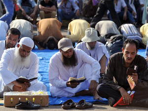 Egyptian supporters of deposed president Mohamed Morsi read the Koran, Islam's holy book, and pray (AFP/FAYEZ NURELDINE)