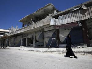 A Syrian resident walks in a devastated street on August 1, 2013 in a street of the city of Qusair, in Syria's central Homs province. (AFP)