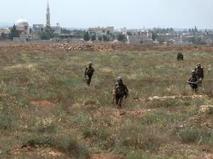  Syrian army soldiers walking nearby facilities of Dabaa military airfield during an operation that led to the control of the airport, north of the Syrian city of Qusayr. AFP Photo